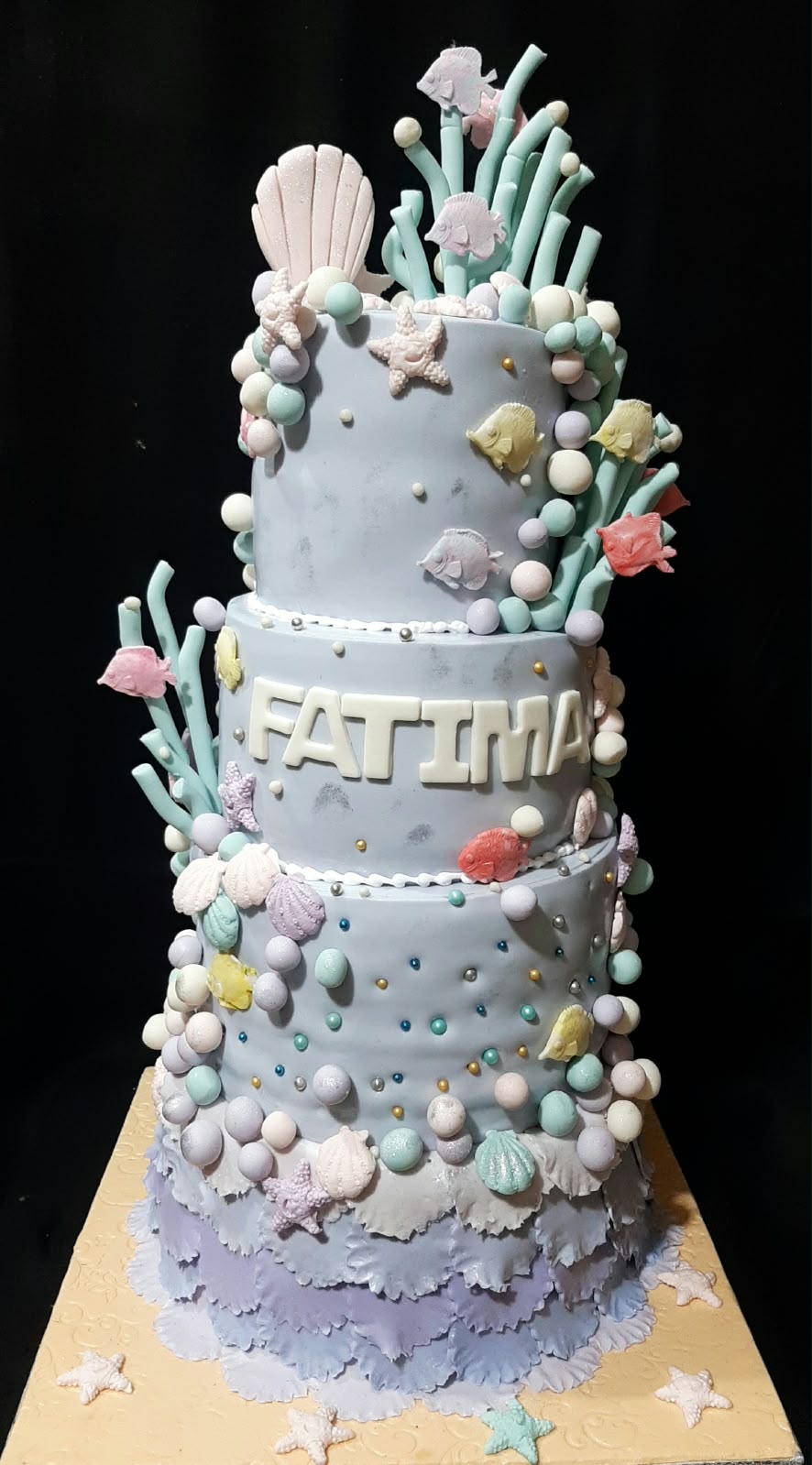 3-tier light blue fondant under the sea birthday cake with sugar fish, coral, starfish, pearl bubbles, and personalized FATIMA name lettering
