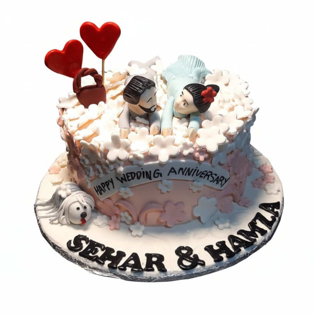 Happy Wedding Anniversary white blossom cake with couple figurines, fondant puppy and red heart lollipop toppers by Marbella Cakes