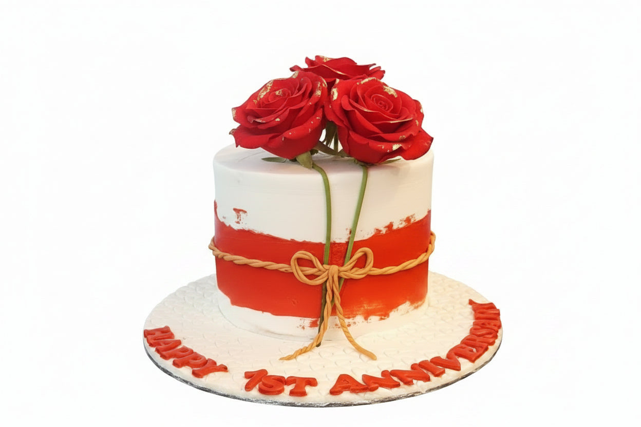 Happy 1st Anniversary red and white fondant cake with gold-tipped red rose bouquet topper and golden rope bow by Marbella Cakes