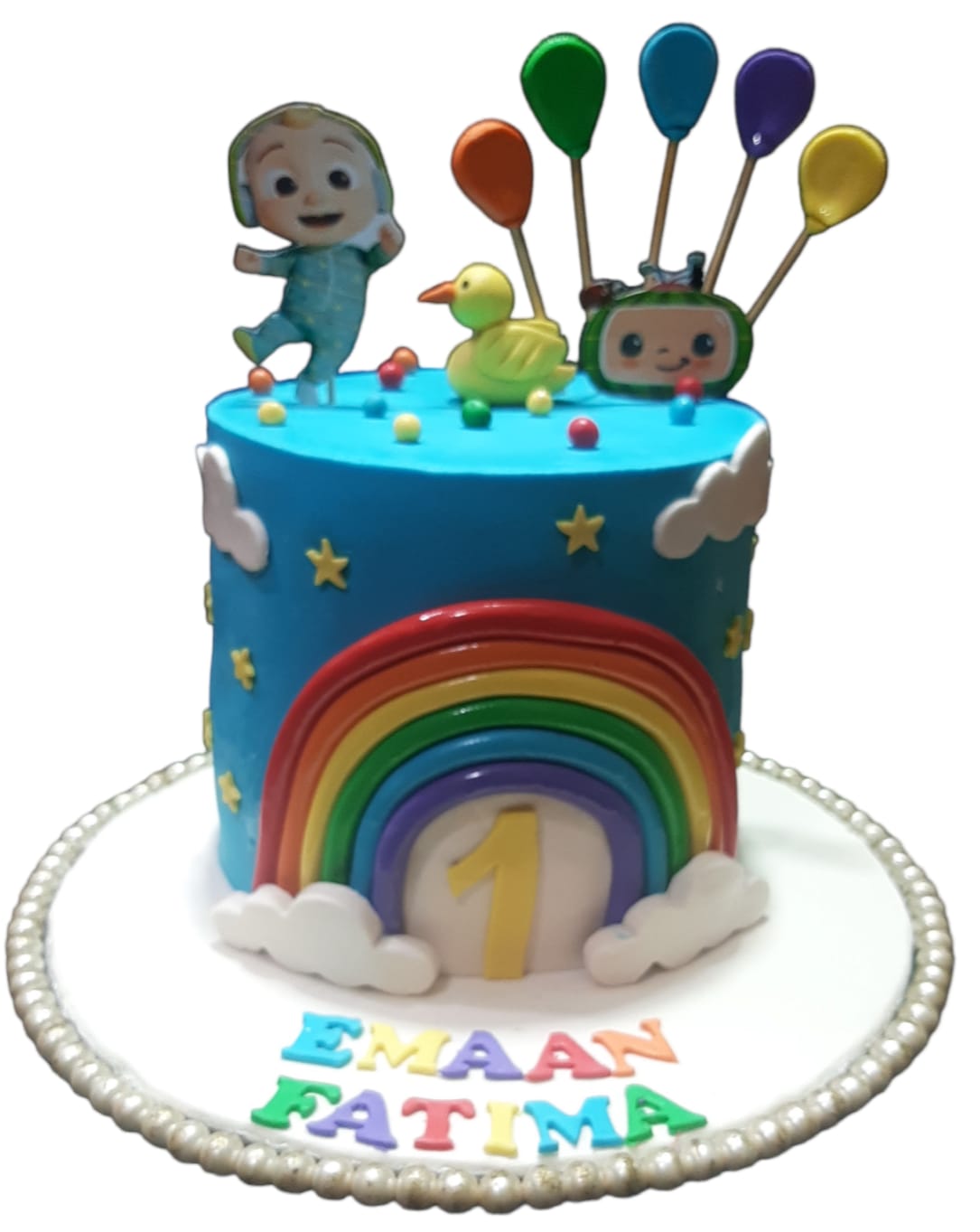 CoComelon Rainbow Arc Birthday Cake with blue buttercream, fondant rainbow arch, JJ character topper, balloon sticks, rubber duck, and personalized name board