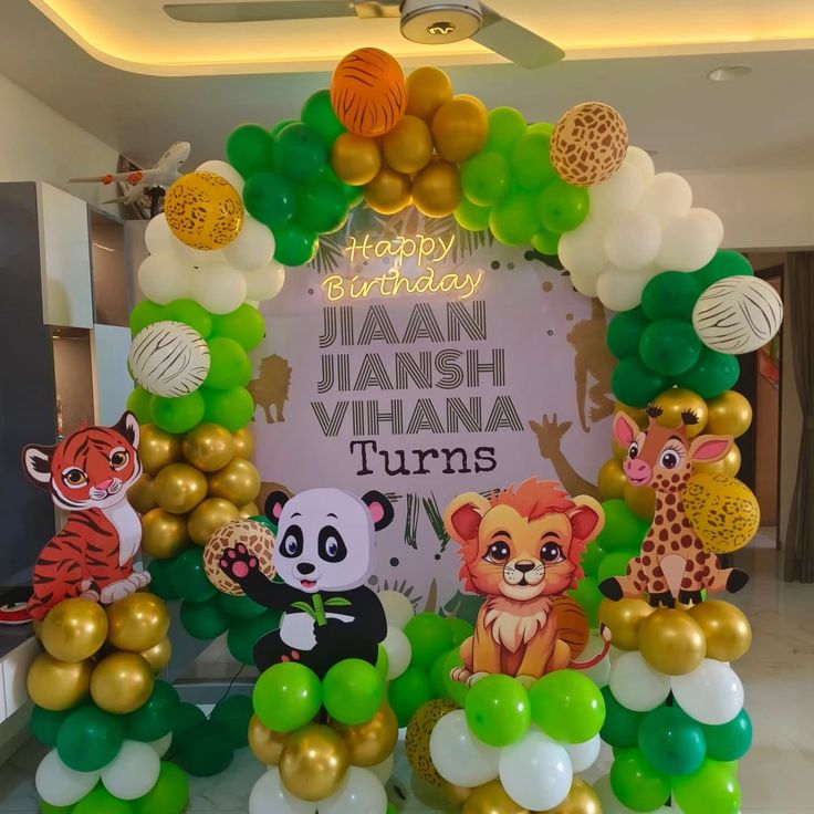 Jungle safari birthday decoration with green gold balloon arch, tiger panda lion giraffe cutouts and custom backdrop