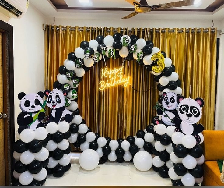 Panda birthday decoration with black and white balloon ring arch, panda cutout standees, Happy Birthday neon sign and gold curtain backdrop