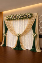 Emerald green and ivory floral drape backdrop with white fairy light curtain, white blush floral runner on top and rose tie-backs