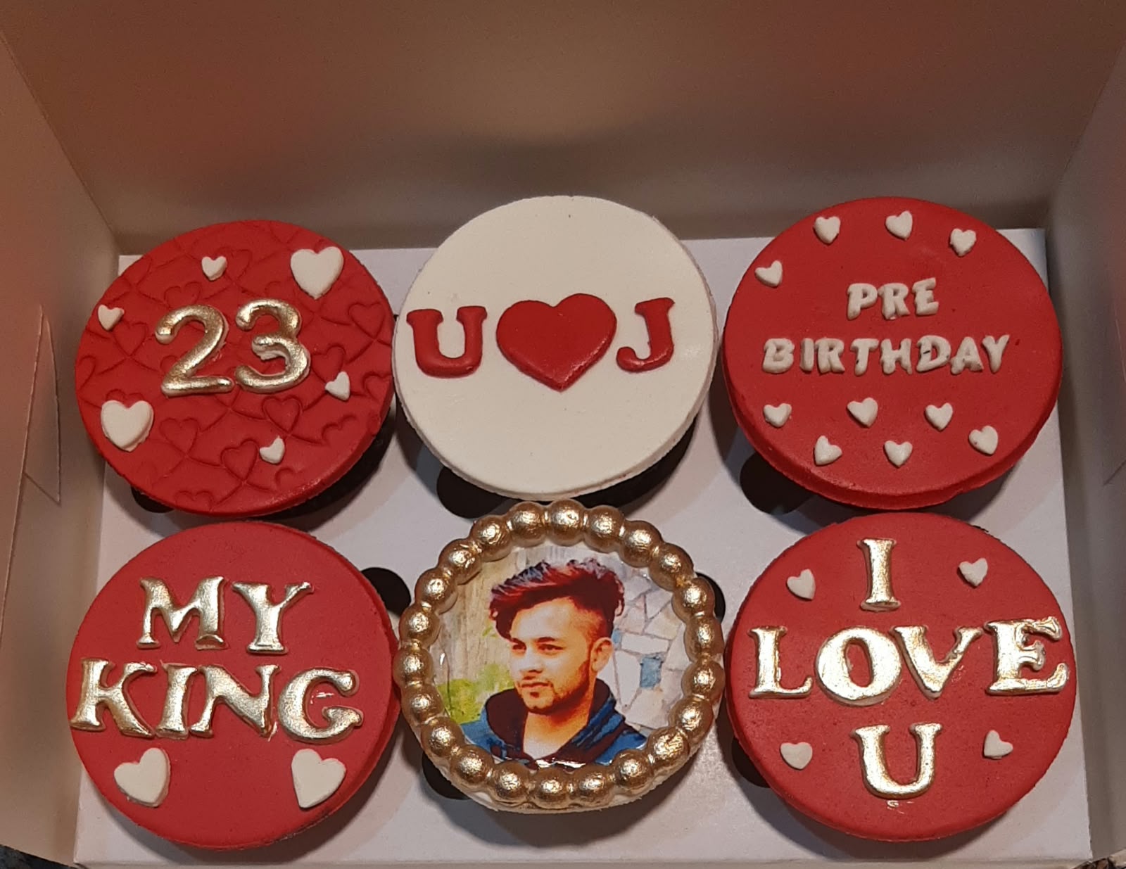 Box of 6 romantic birthday surprise cupcakes in red and white fondant with gold age number, couple initials heart, Pre Birthday message, My King lettering, edible photo print and I Love U message