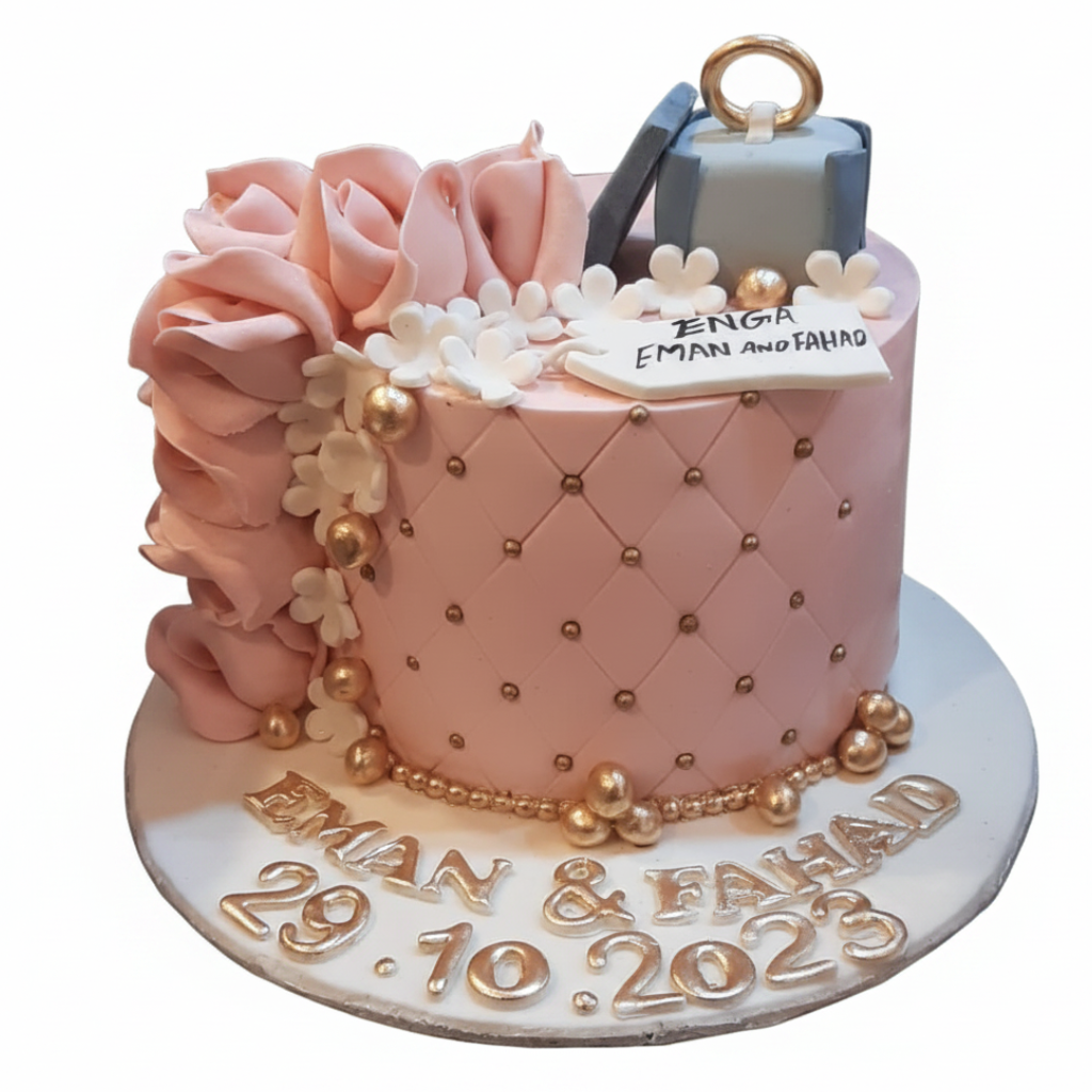 Blush pink quilted engagement cake with blue ring box topper, pink ruffle roses, gold pearl accents and name date lettering on white background