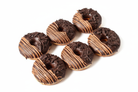 Dark chocolate shaving donuts with milk chocolate drizzle on white background